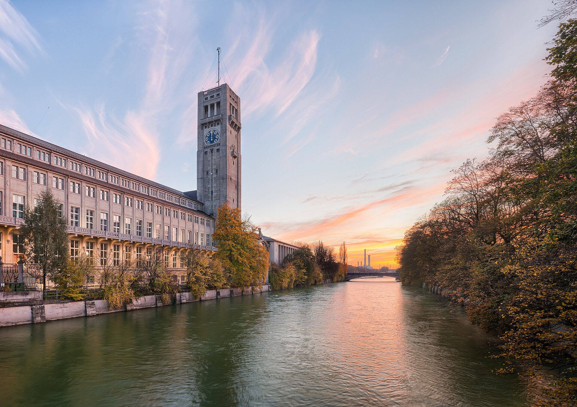 A river running through a European city at sunset